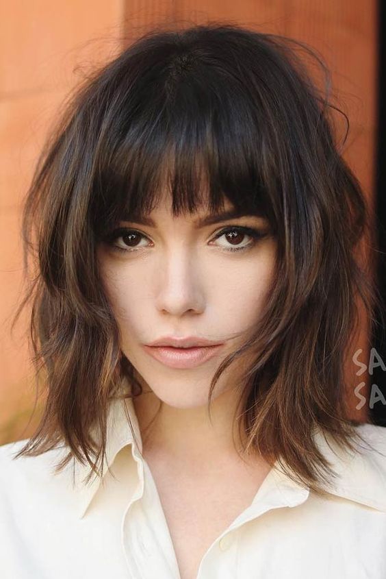 A lovely dark brown long shaggy bob with caramel highlights and a classic fringe, plus messy waves, a cool and chic idea