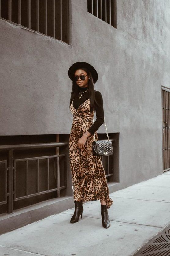 Black turtleneck, leopard print slip dress, black bag, ankle boots, and a black hat, a perfect ensemble for this fall