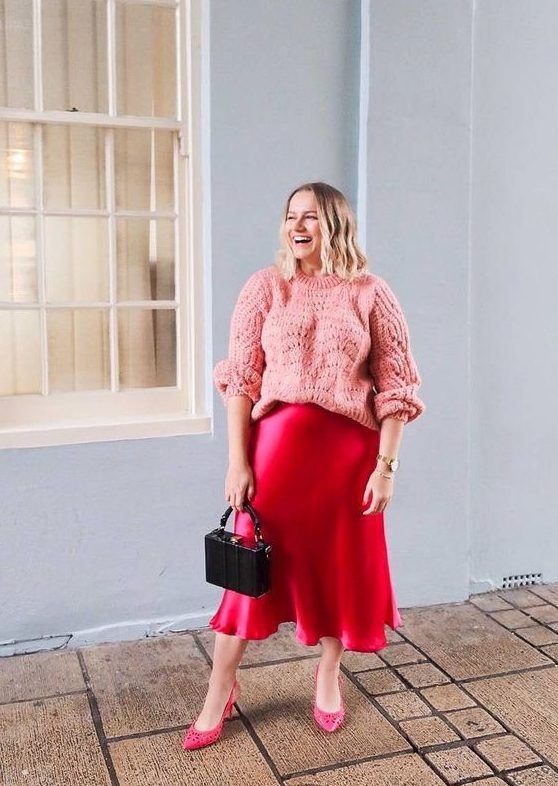 Bright and cute look with a pink oversized jumper, hot pink slip midi, pink shoes, and an elegant small bag