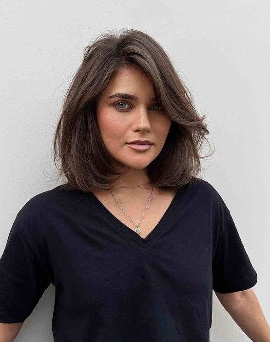 Brown long bob with side bangs, messy waves, and a lot of volume, a chic and lovely idea to rock