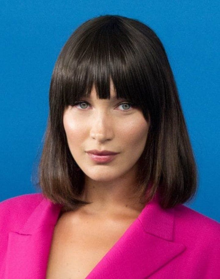 Calling all you '90s lovers! Channel Michelle Pfeiffer's iconic Scarface hairstyle with this curled under long bob and full bangs