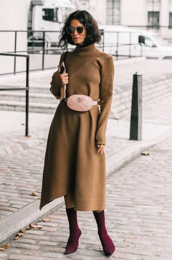 Camel A-line midi knit dress featuring a turtleneck, long sleeves, a blush waist bag, and purple sock boots
