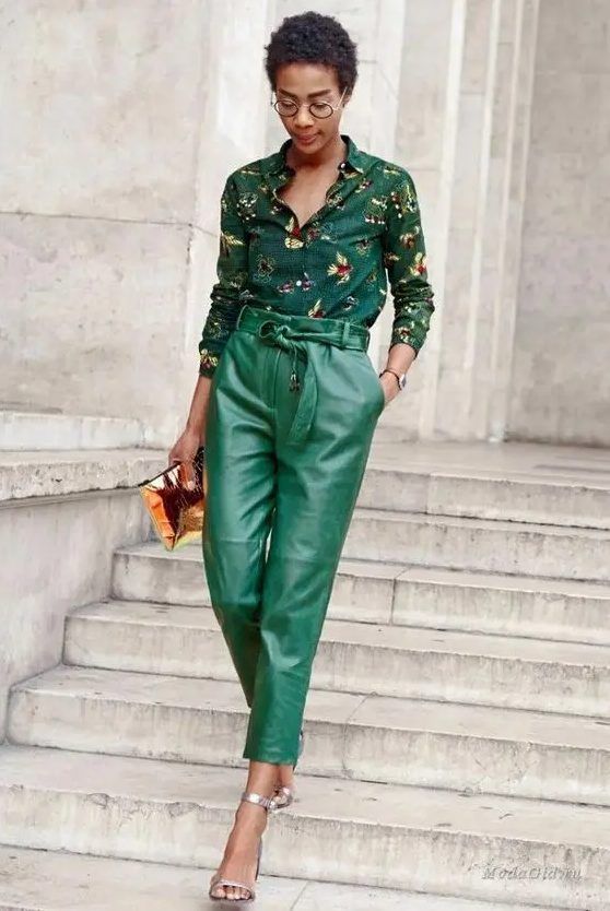 Dark green floral shirt, emerald leather pants, silver shoes, and a bold clutch, a lovely look for a fall wedding