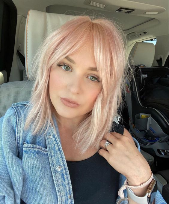 Light pink long bob with curtain bangs, a sweet and cute idea for a modern and bold look