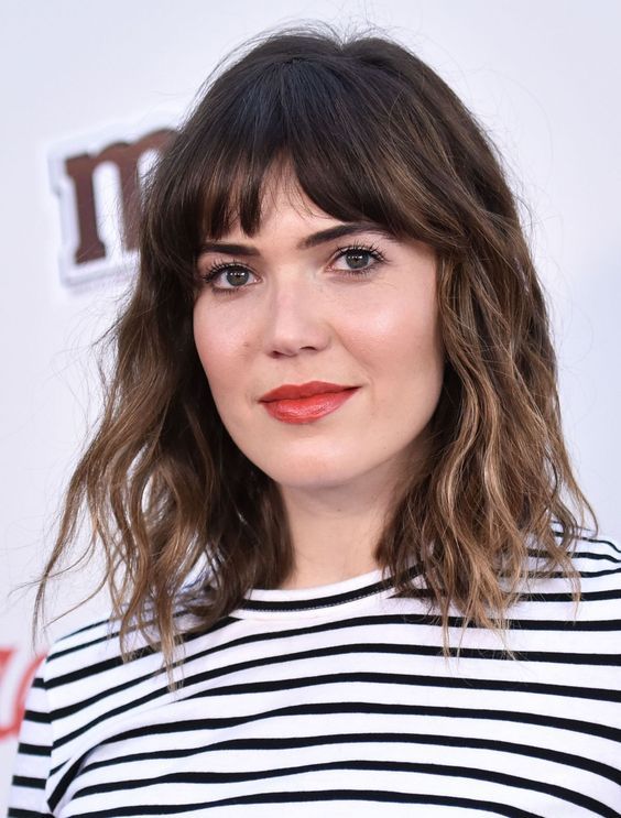 Long dark brunette bob with bronde balayage, bottleneck bangs, and waves, a chic and French-inspired idea