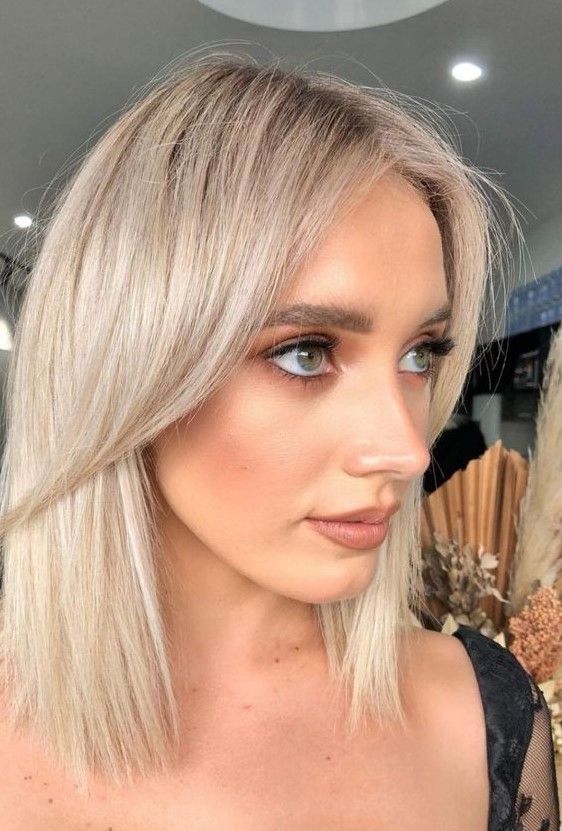 Long platinum bob with curtain bangs, a chic and cool idea that looks feminine and soft