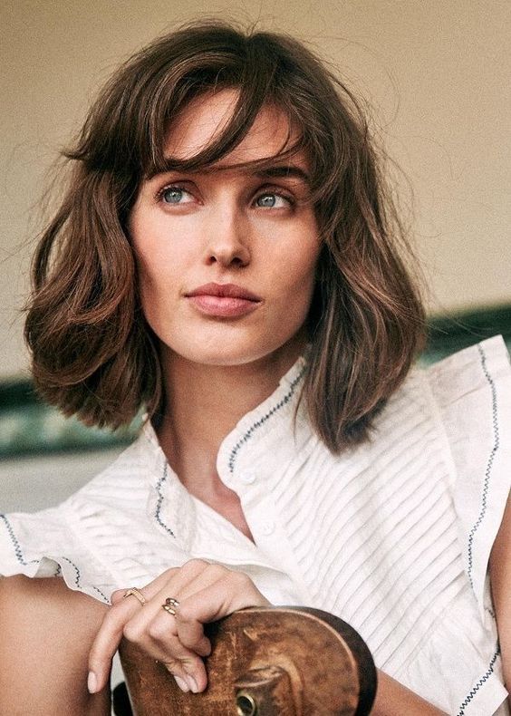 Messy brown long bob with bottleneck bangs and messy texture and volume, a chic and lovely idea