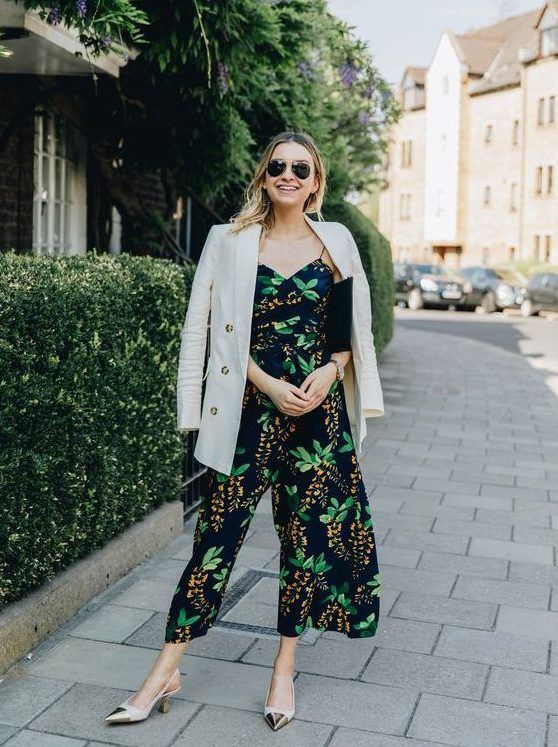 Moody botanical print jumpsuit with culottes, trendy slingbacks, black clutch, and a neutral blazer