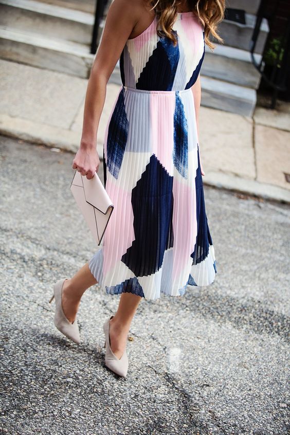 Navy, white, and pink color block print midi pleated dress with spaghetti straps, a blush clutch, and white shoes