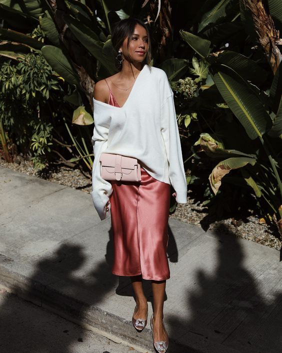 Pink slip midi dress, white pullover on top, blush buckle shoes, and a small blush bag for a spring to summer look