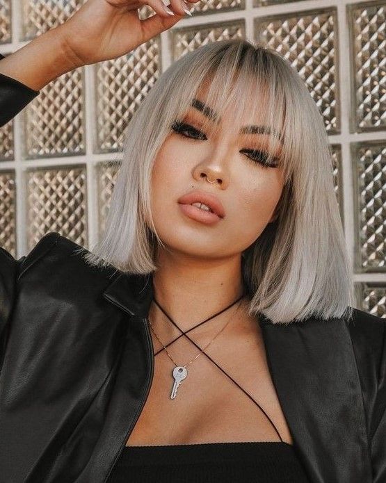 Platinum blonde straight long bob with wispy bangs is a stylish and catchy idea that will make you stand out