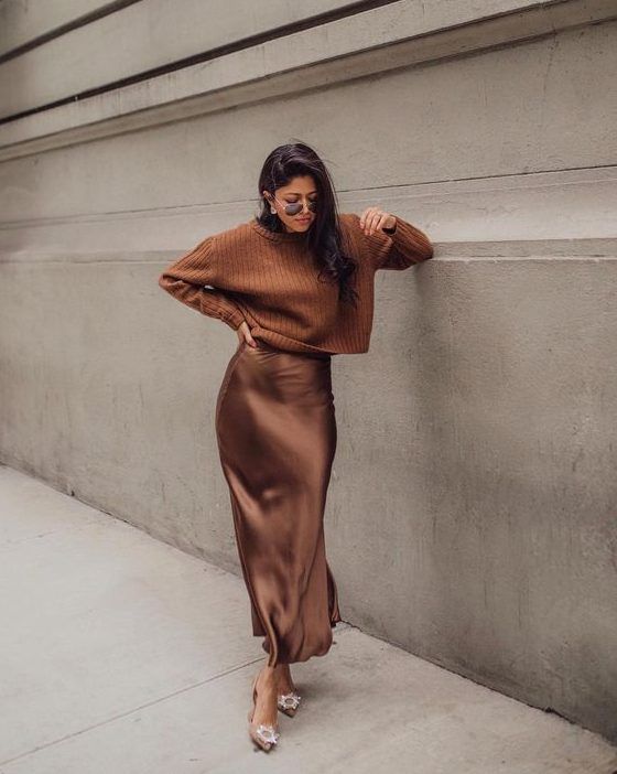 Pretty and girlish fall outfit with a brown jumper, a brown silk midi skirt, and beige shoes