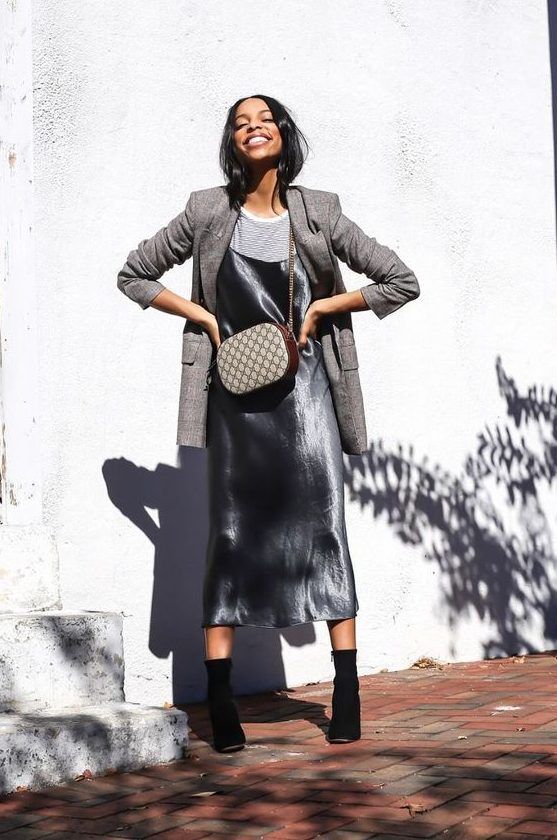 Striped tee, silver slip midi dress, grey plaid blazer, black sock boots, and a printed bag